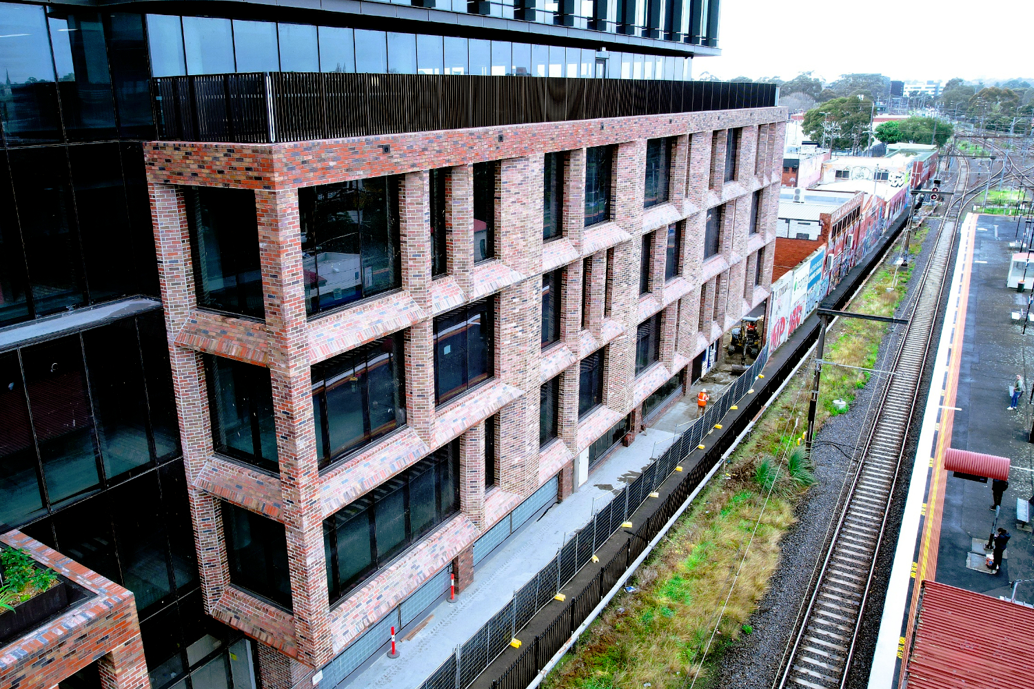 Lightweight Truecore steel framing custom modular façade with brick-slip system on Australia Post National Support Centre building at 480 Swan Street in Richmond, Melbourne, Victoria, next to Burnley Station, designed by CMG Frames.
